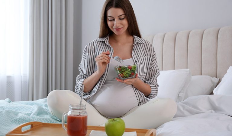 A healthy pregnant woman having a bowl nutritional food to gain weight