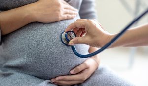 Prenatal care check-up of a pregnant woman by a doctor
