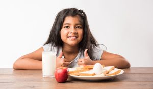 A little Indian girl having protein-rich food