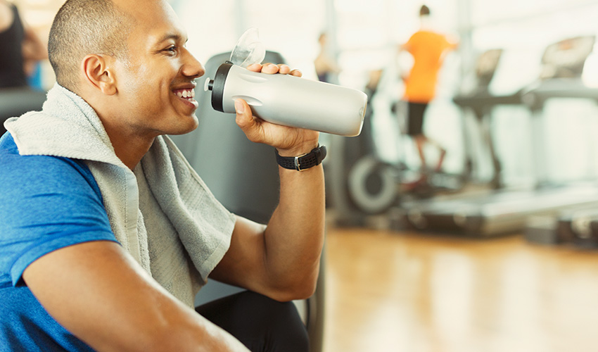 A young male having a nutrition drink post work out